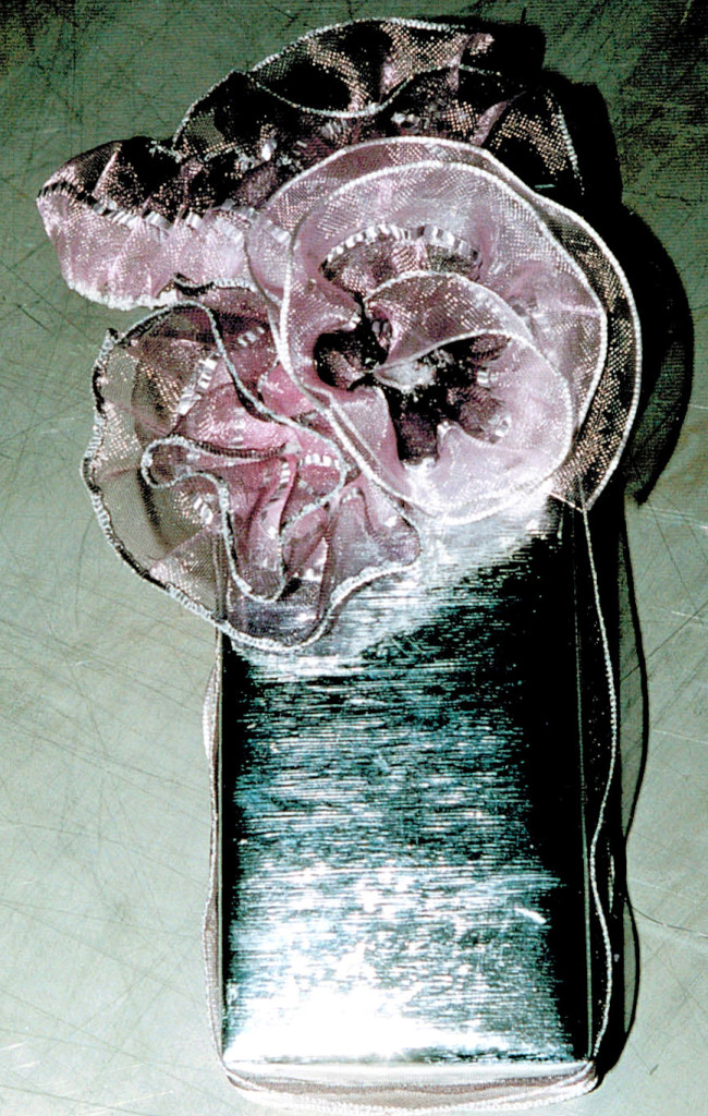 1.version of box covered in silver foil, silver-violet shaded, pushed ribbon, partly formed as rosettes