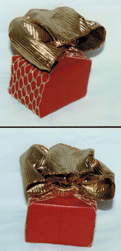 small box in gold.net ribbon, large bow hold with a plastic ring